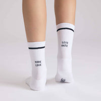 White socks with text worn by a person on a light gray background